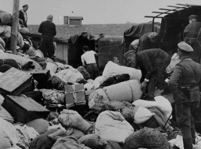 Prisoners unload the confiscated property of a transport of Jews
